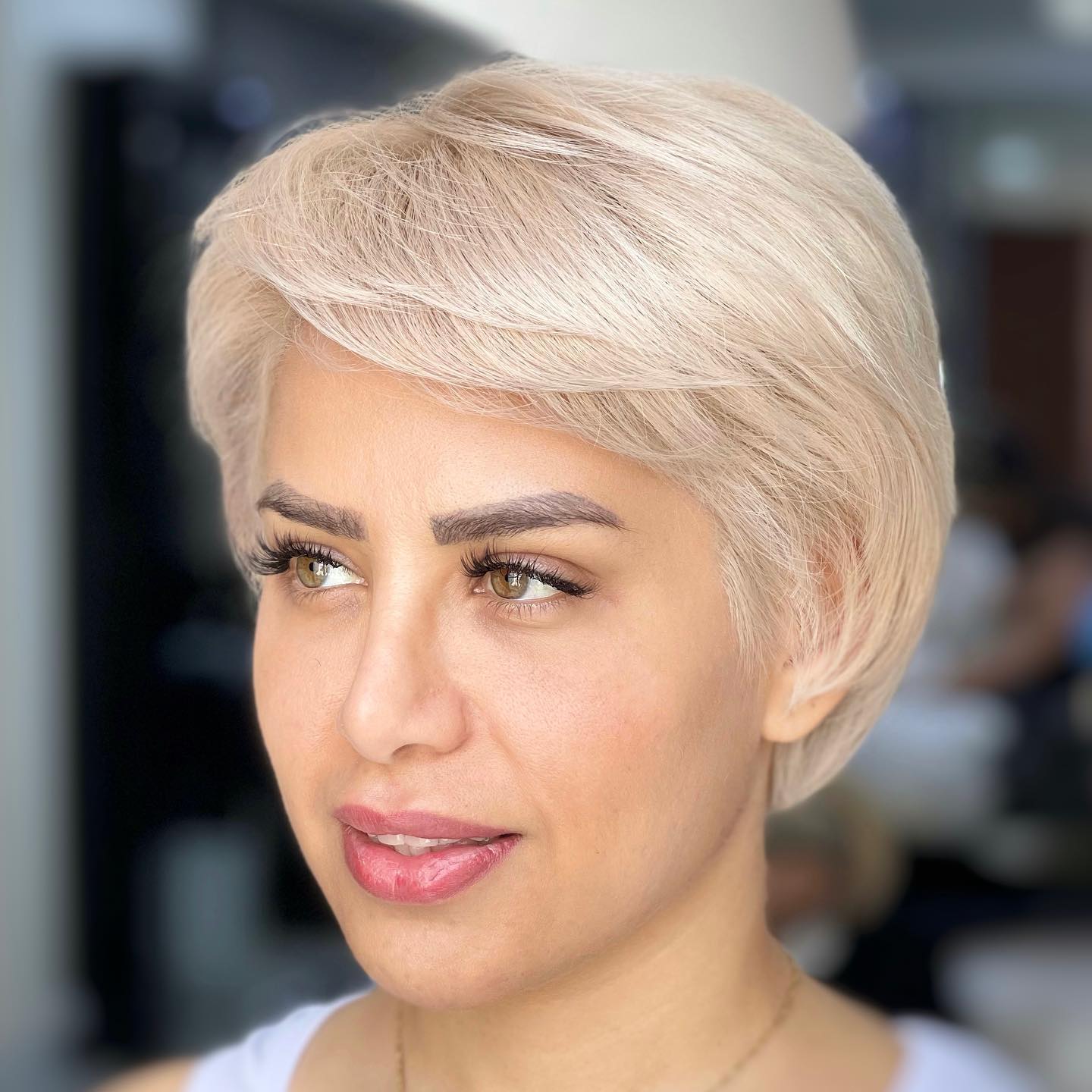 Polished Short Blonde Cut with Layered Bangs